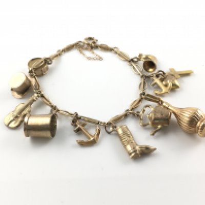 A 9ct gold charm bracelet with assorted charms. 12.67g Postage B