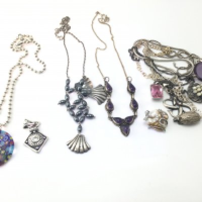 A collection of silver necklaces and pendants. Postage B