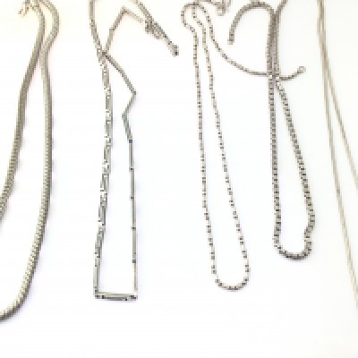 A collection of 5 silver necklaces. Postage B