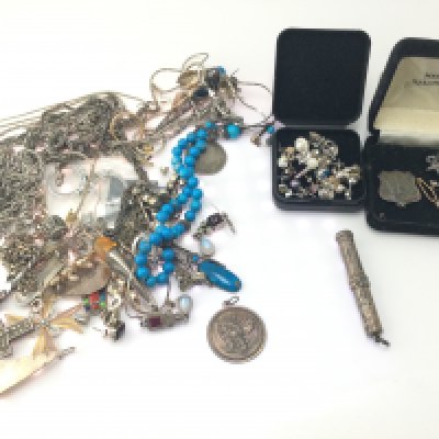 A collection of assorted silver items including earrings pendants chains etc.