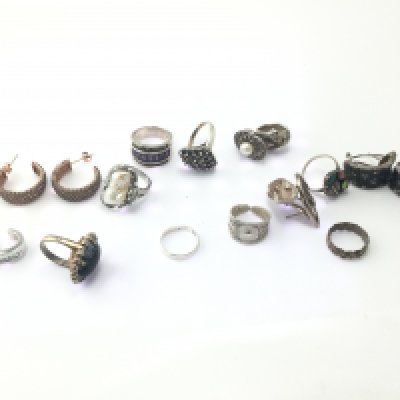 A collection of assorted silver rings and earrings. Postage B