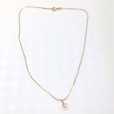 A 9ct gold chain with a stone set heart pendant. 1.62g