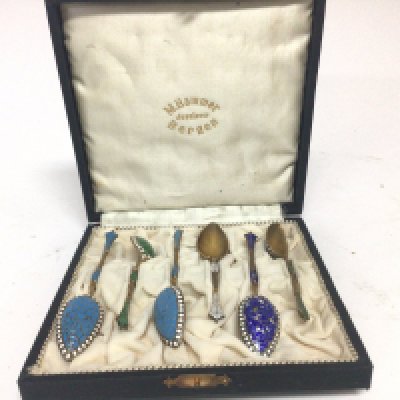 A cased set of six coloured enamel and silver Norwegian teaspoons spoons