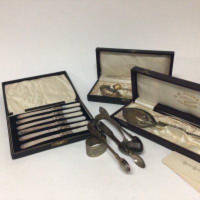 A collection of cased Norwegian silver spoons and a set of silver plated and mother of pearl handled butter knives silver sugar tongs.