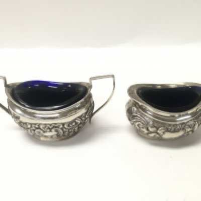 Two sterling silver salt dishes with blue glass liners. Approx weight without liners 59.17 grams.