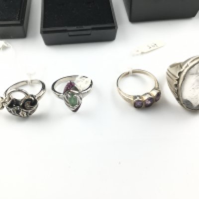 Four silver rings including an enamelled heart and lock ring and a marquise cut emerald and rubies ring. Postage B