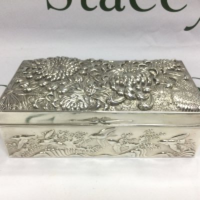 A heavy Oriental white metal trinket box, heavily embossed, slight damage to hinge, approx 900g. Shipping category B.