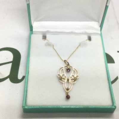 A 9ct gold Art Nouveau pendant on a 9ct gold chain. Shipping category A.