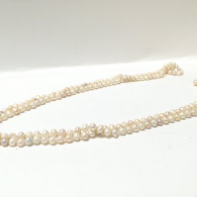 A 64 inch long white pearl necklace , postage category A