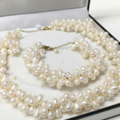 A pearl and silver gilt necklace, bracelet and earring set , postage category B