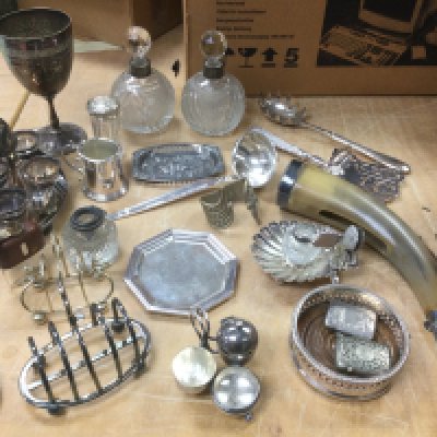A box of silver plated items including vesta cases, bottle coaster etc. Shipping category D.