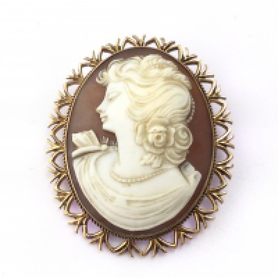 A yellow metal cameo brooch. Postage B