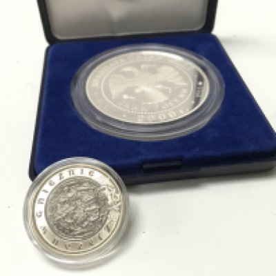 A Russian 900 silver medallion, 25 rubles 140 years of the Bank of Russia Silver 900 pr Weight 155.5G, and a silver polish coin. Postage cat A