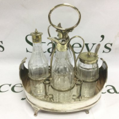 A Regency silver plated cruet set decorated with an Irish guards crest. Shipping category D.
