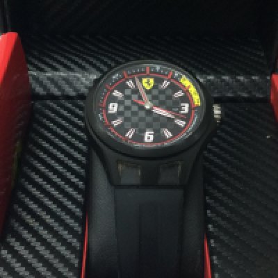 A boxed Gents Ferrari watch, seen working. Postage category B