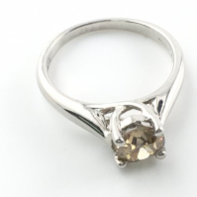 An 18ct white gold brown diamond solitaire ring. 1.01ct size J and 3.59g Postage A