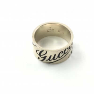 An 18ct gold Gucci ring. 8.94g and size M. Postage A