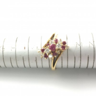 An 18ct diamond and ruby ring. Size K and 3.76g