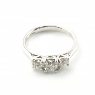An 18ct white gold graduated diamond trilogy ring. Size M diamonds approximately 0.98ct with cert. Postage A