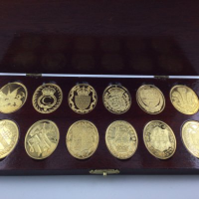 A cased set of silver gilt medallions the arms of the prince and princess of wales.Postage B