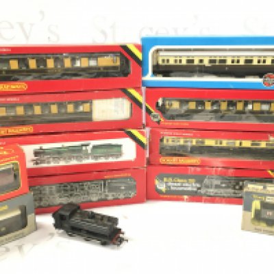A Box Containing A Collection of Boxed And Loose 00 Gauge. Including Locos. Coaches wagons. Etc. No Reserve.