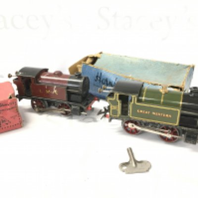 A Box Containing 2 X 0 Gauge Locomotives Track, Buildings And empty Boxes.