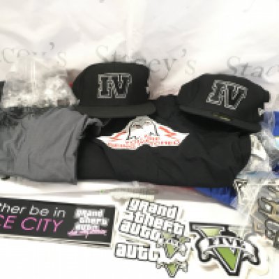 A Collection of Rock Star Games Grand Theft Auto Promotional Items Including Stickers. T-Shirts. Caps. Pin Badges. Etc.