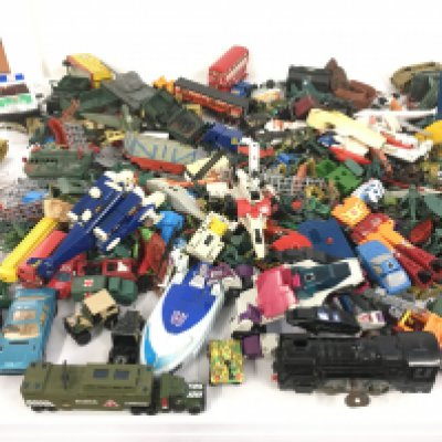 A collection of Playworn diecast and plastic vehicles including some military items. Clockwork train and tinplate tank. Also includes and some transformer style pieces and planes. Also some plastic toy soldiers included. No reserve
