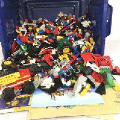 A box containing a large quantity of loose Lego building blocks and accessories. Also includes some leaflet but not necessarily matched to contents. No reserve