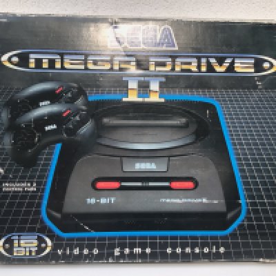 A boxed Sega Mega Drive 16 bit video games console. Includes 2 controllers and power supply. Also has 4 boxed games. Instructions included.