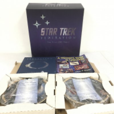 A collection of Star Trek pieces including two boxed Hamilton plates and a boxed Federation the first 150 years with book. Plus Trekkers Guide to Collectibles. No reserve