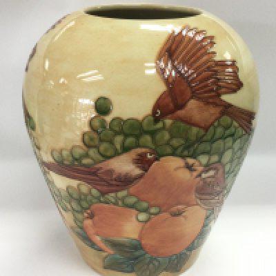 A large Moorcroft vase depicting finches and fruit designed by Sally Tuffin, WM 1989, height approx 30cm. Shipping category D.