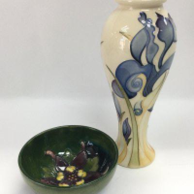 A Moorcroft pin dish in Columbine pattern and a Moorcroft blue and cream floral vase, 2009 and marked as a second, approx height 20cm (2). Shipping category D.