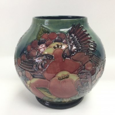 A Moorcroft ovoid vase decorated with blue finches and fruit, approx height 16.5cm. Shipping category D.