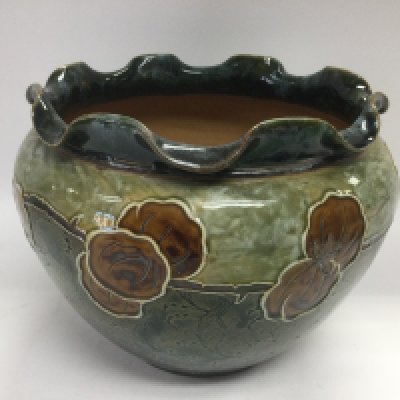 A Doulton Lambeth vase of ovoid form and decorated in browns and greens, approx height 17.5cm. Shipping category D.