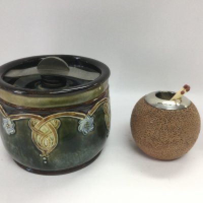 Two Doulton Lambeth items comprising a tobacco jar and a silver rimmed match strike (2). Shipping category D.