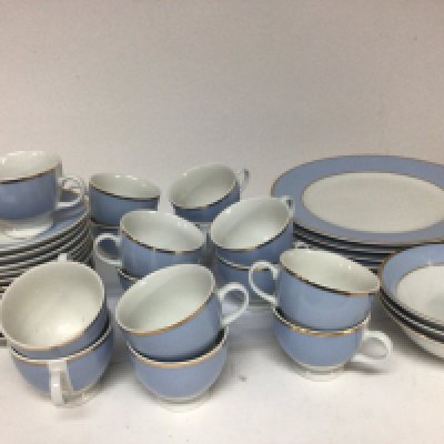 A Royal Doulton tea and part dinner set decorated in pale blue with applied gilt and a Doulton crystal bowl boxed. NO RESERVE