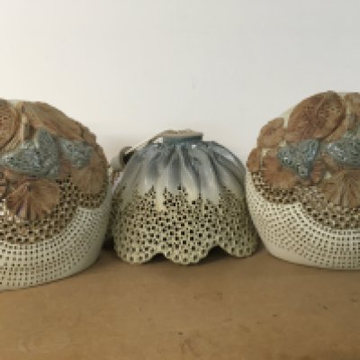 A pair of Bernard Rooke wall lights together with a lamp shade.