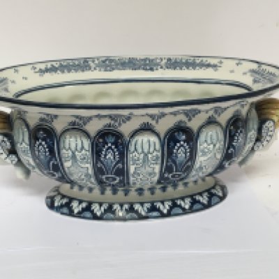 A Quality Continental late 19th century blue and white jardiniere of oval shape with raised and applied heads. Impress marks to the base. 44cm wide.