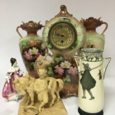 A Late Victorian ceramic clock garniture A Royal Doulton Issac Walton ware Vase a ceramic figure of a working horse and a Doulton figure.