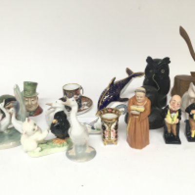 A Royal Crown Derby porcelain dolphin other Royal Crown Derby a Worcester candle snuffer in the form of a Monk Doulton figures a black Forest owl string holder and other oddments.