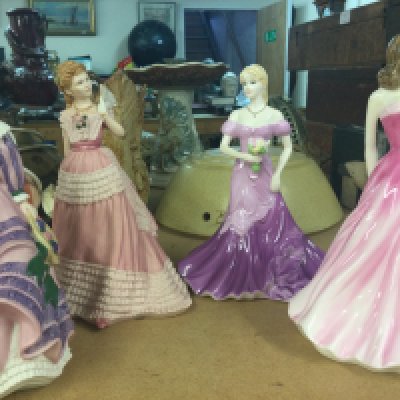 A collection of eleven figurines including Doulton wedgewood and Coalport .