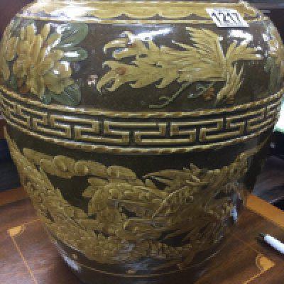 A large pottery chines style vase the brown glaze with raised dragons flowers and foliage. 40 cm .