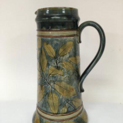 A large Royal Doulton stoneware jug with impressed leaf pattern on a blue green ground. Height 36cm