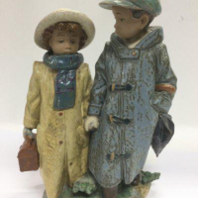 A Lladro figural group of a boy and a girl, possibly evacuees, approx height 27cm. Shipping category D.