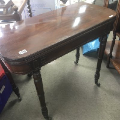 A late George III mahogany card table with a hinged top on turned legs. NO RESERVE
