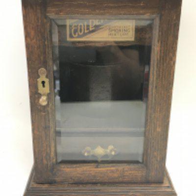 A vintage smokers cabinet with glass door, pipes, an unopened packet of tobacco and a bowl. Dimensions 22x20x28.5cm
