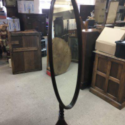 A reproduction Mahogany oval mirror on stand , 161cm. This lot cannot be posted