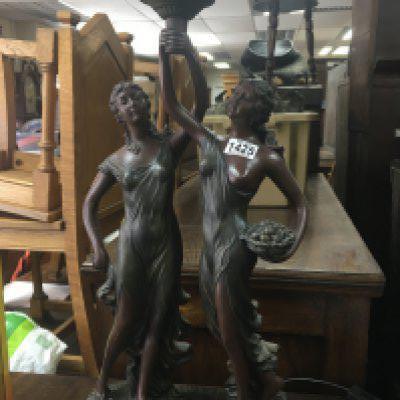 A modern lamp in the form of two classical maidens holding a frosted glass Shade .78 cm .