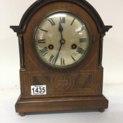 An Inlaid Edwardian mantel clock with brass pillar supports height 31cm